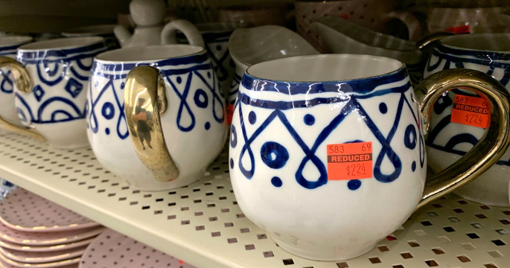 blue and white coffee mug with orange stickers