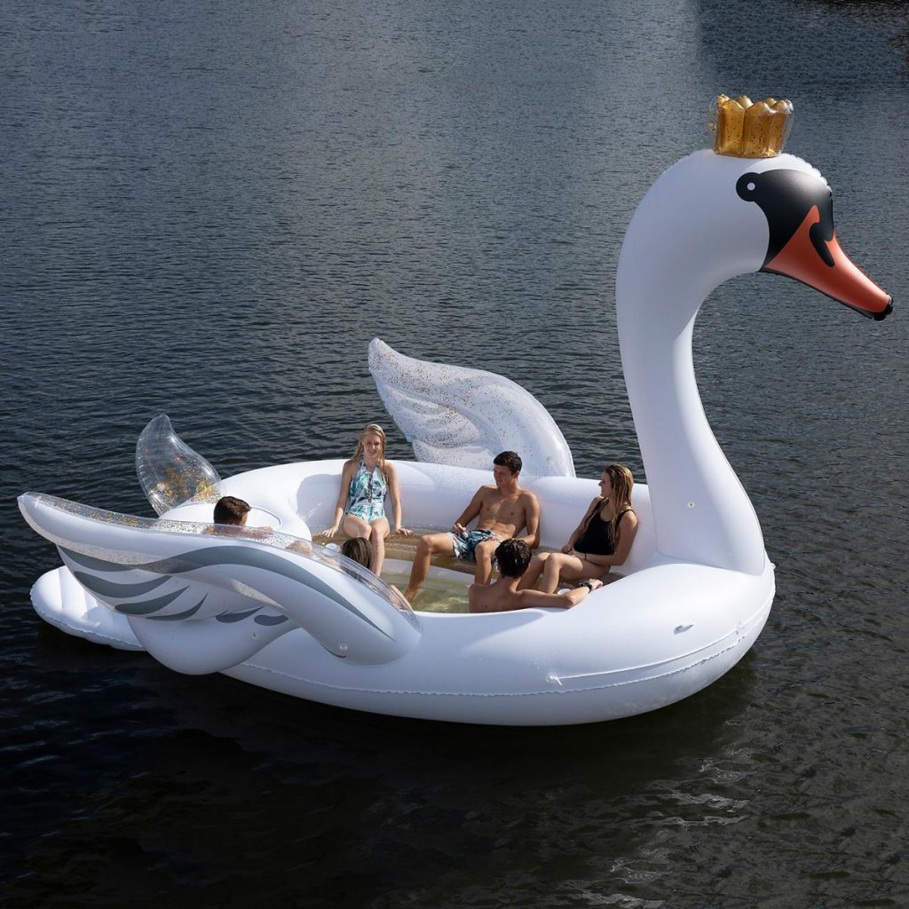 swan inflatable island with people on it