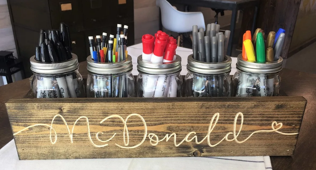 mason jar centerpiece filled with office supplies 