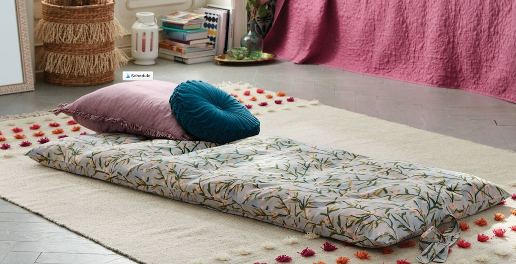 floral throw bed on bedroom floor 