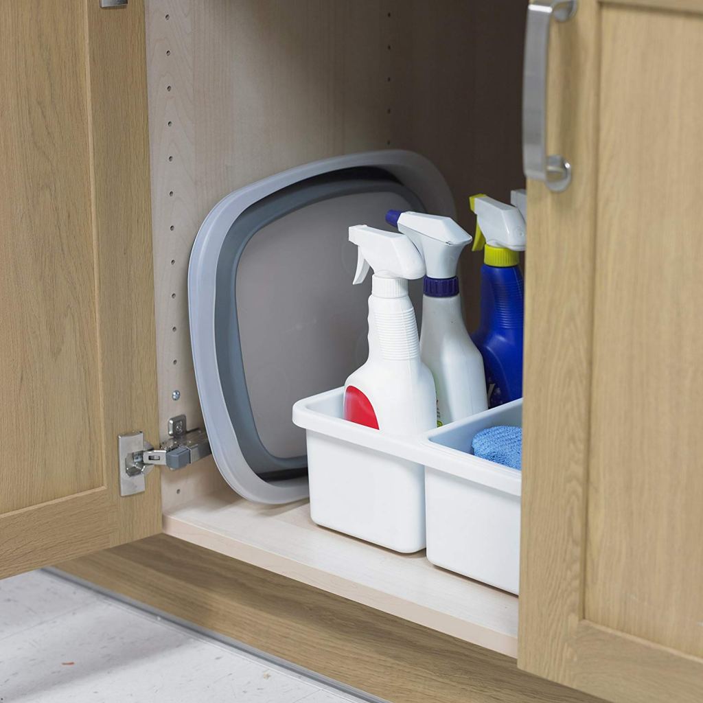 collapsible dishpan with cleaning supplies under cabinet