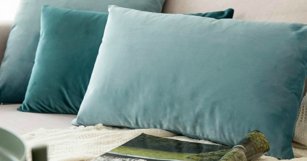 blue velvet throw pillows on couch 