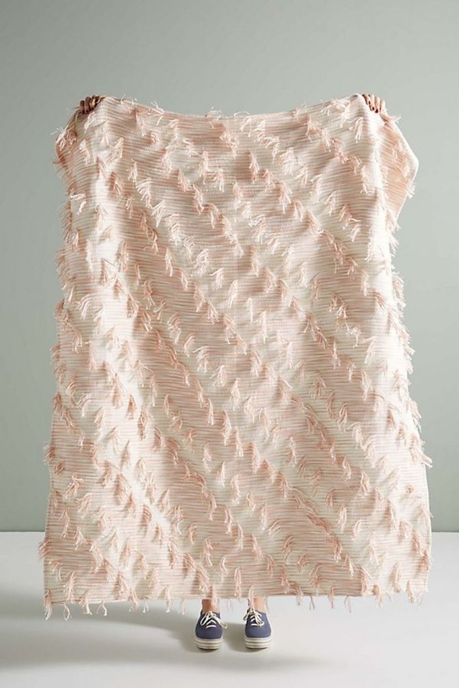 holding Anthropologie throw blanket 