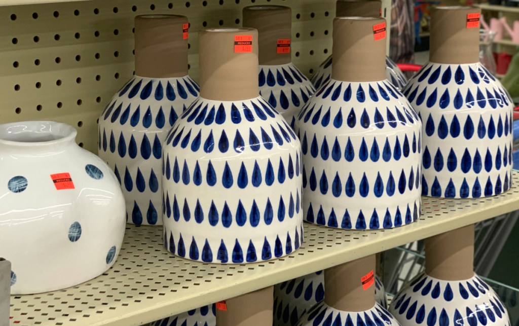 blue and white small vase on shelf