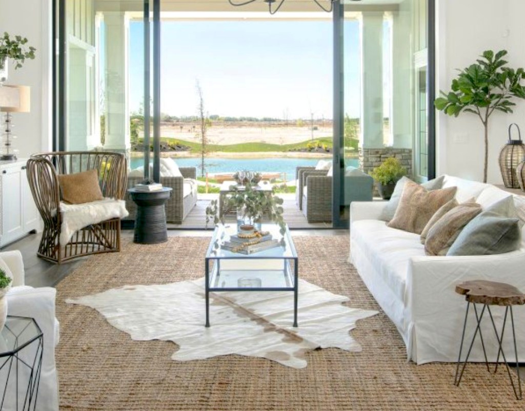 beautiful coastal living room with white furniture and great views outside