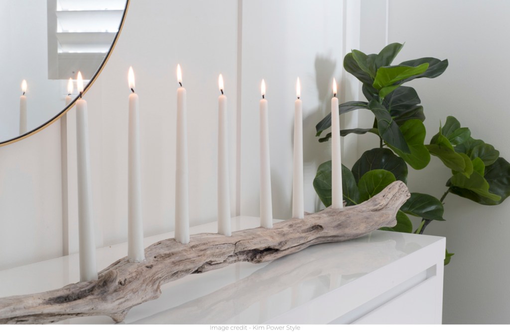driftwood candle holder on white glossy surface