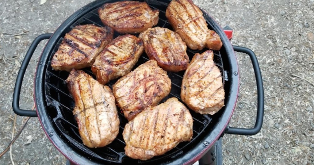 chicken breasts cooking on a grill