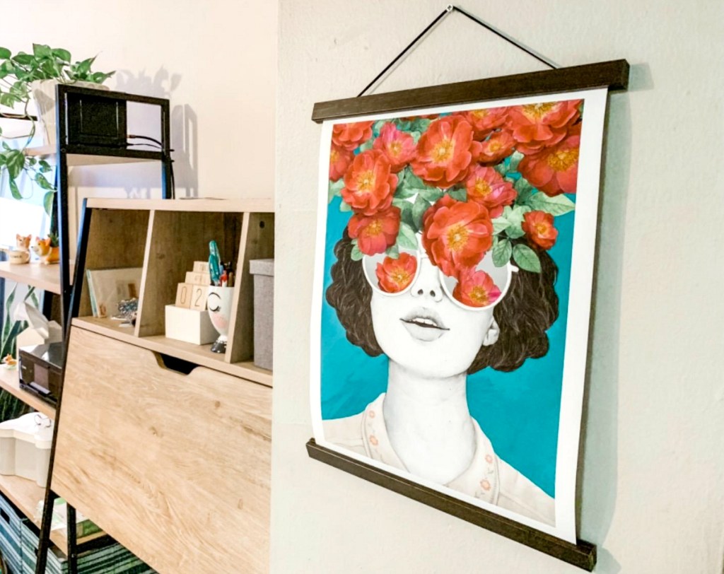 hanging picture of woman and flowers on wall