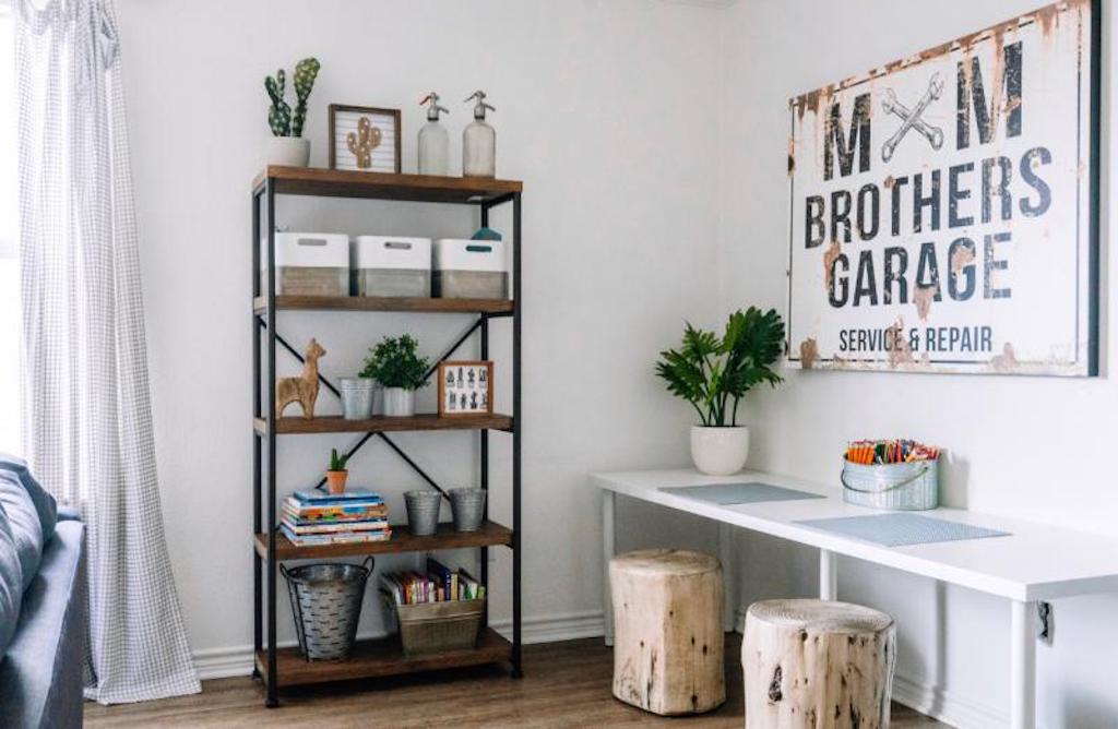 Industrial bookshelf next to table with stools 