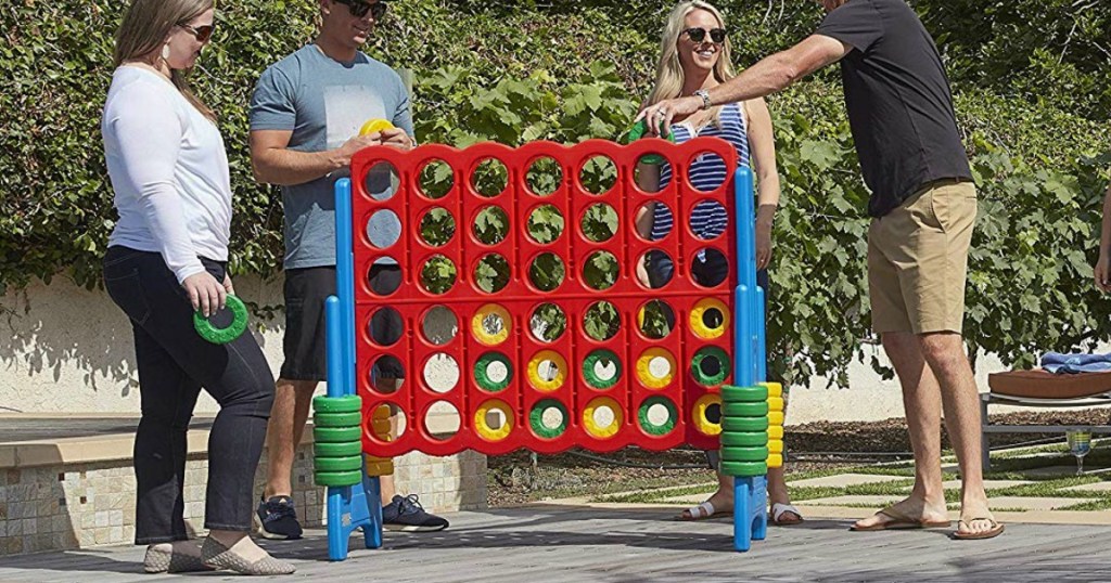 people playing with giant outdoor connect 4 board game