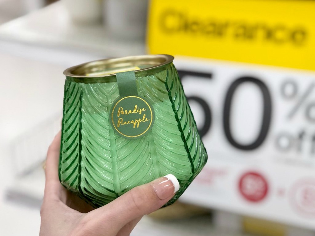 hand holding green candle in a store