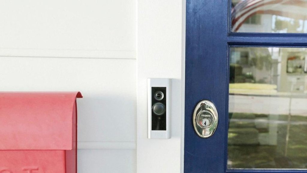 ring doorbell on white trim work and blue door