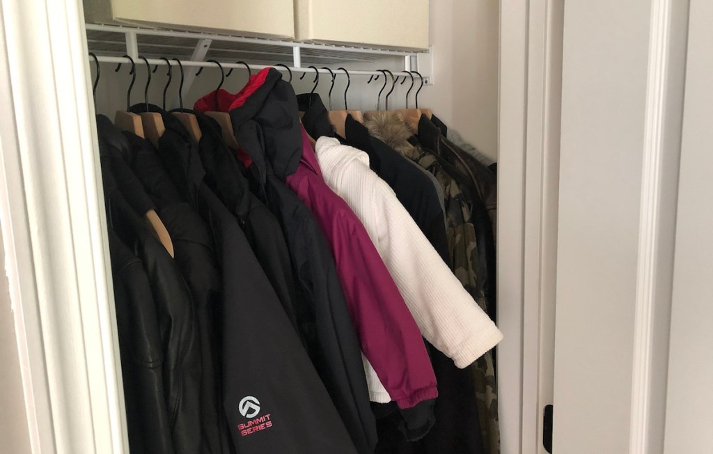 small coat closet with jackets hanging inside
