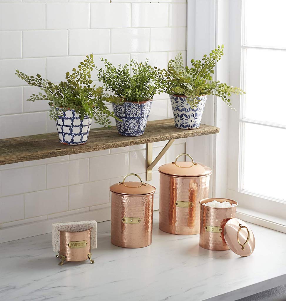 plants on shelf with copper containers and sponge holder 