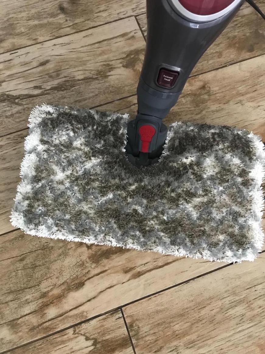 steam mop with dirty pad on hardwood floors 