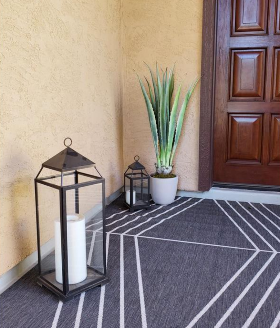 faux plant and candle in entryway by front door