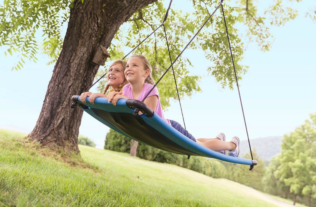 2 girls having fun swinging