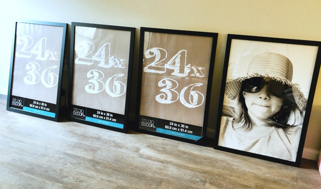 4 black poster frames on the floor