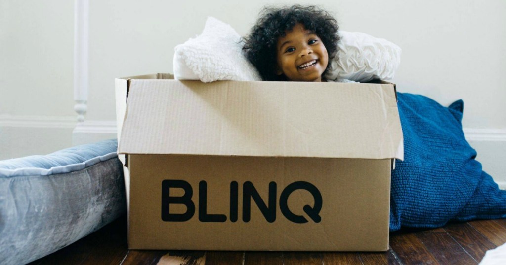 little girl popping out of BLINQ shipping box 