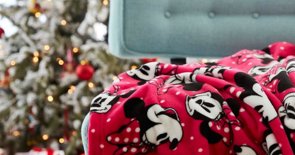 Disney blanket on chair with Christmas tree in the background 