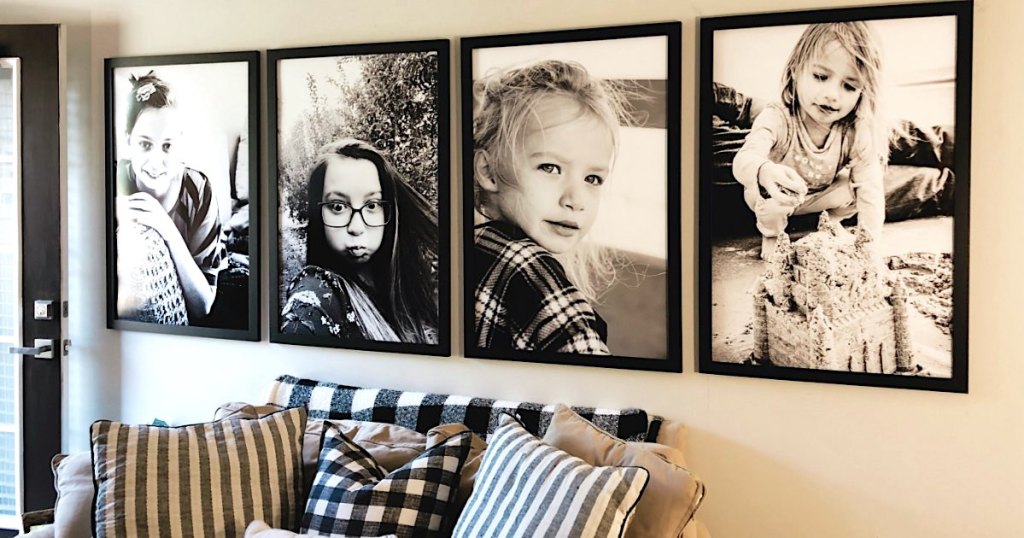 photo gallery with 4 black and white framed poster prints over couch 