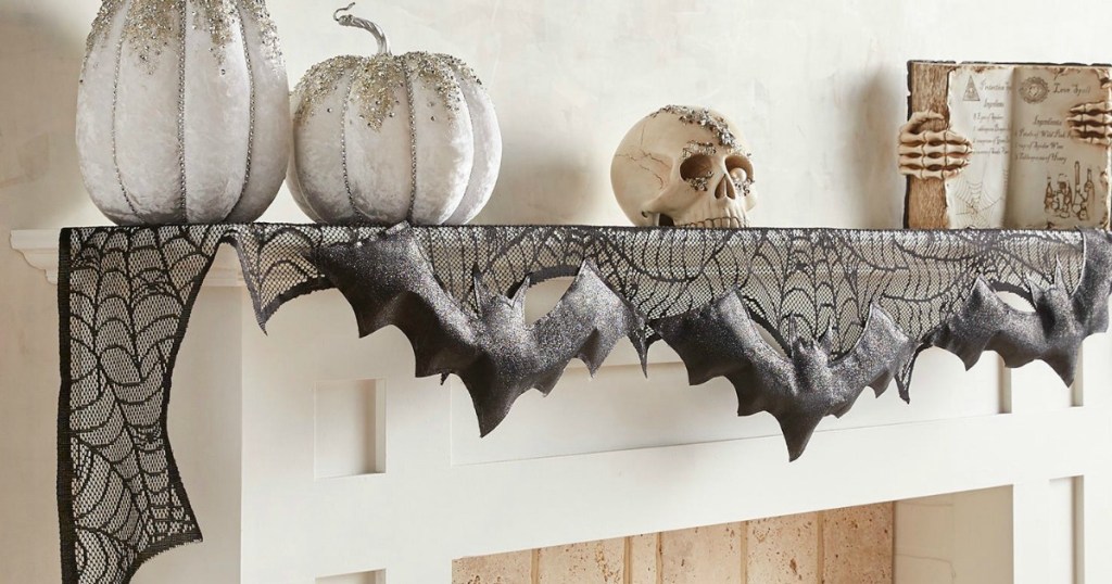 mantle decorated with Halloween pumpkins and skull 