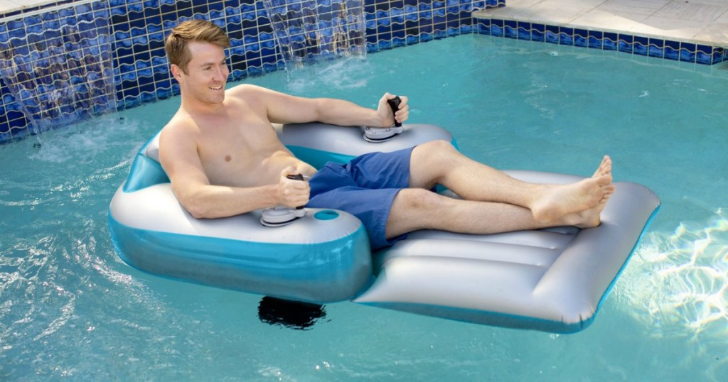 man riding motorized pool float in pool 