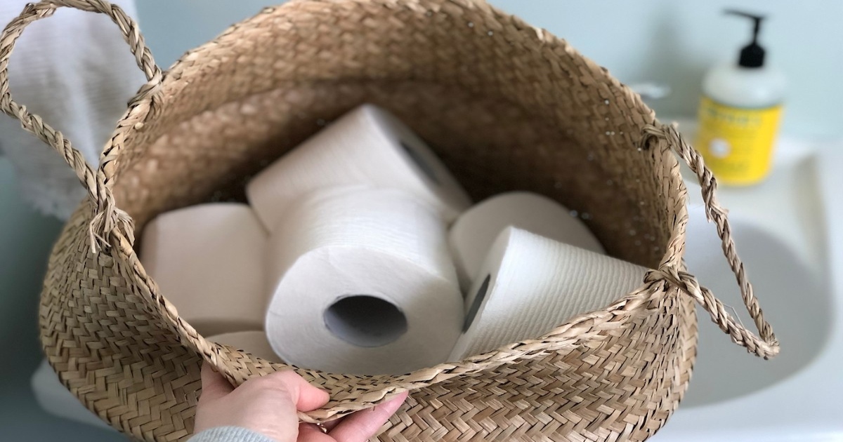 a basket of toilet paper above a sink