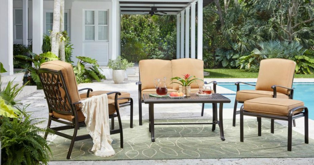 large outdoor aluminum patio set with cushions by pool 