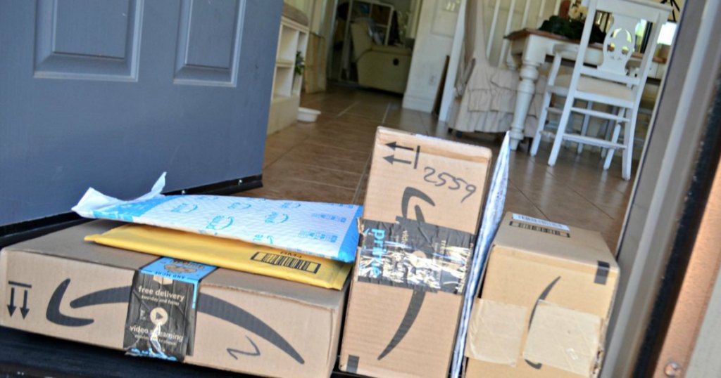 Amazon boxes stacked on front door 