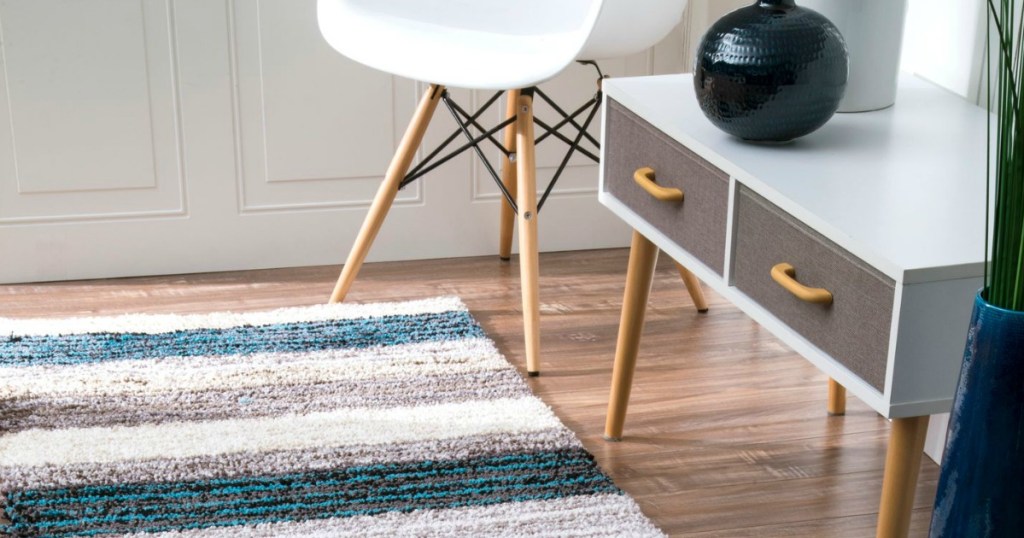 striped area rug on hardwoid floor with furniture 