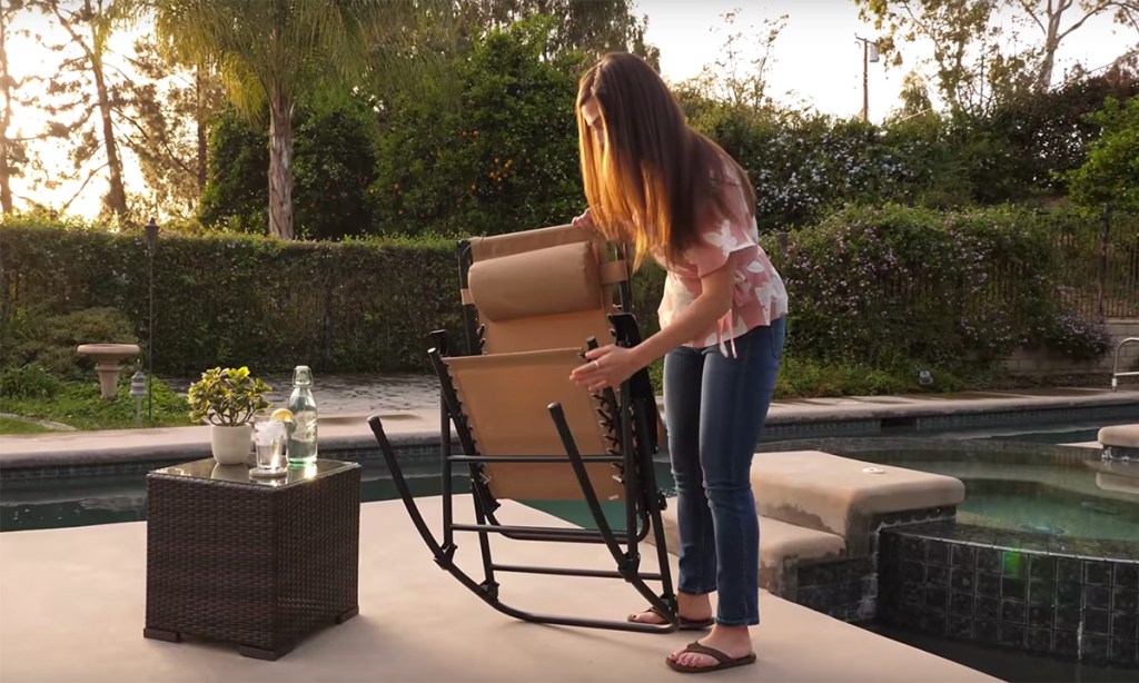 woman folding zero gravity chair