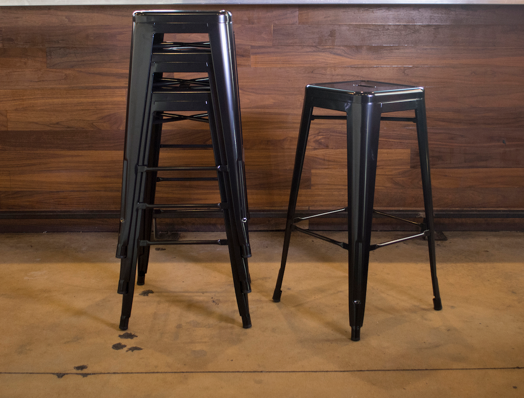 black bar stools stacked up 