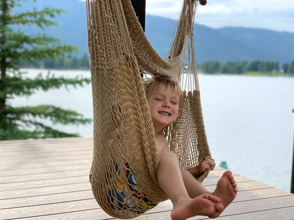 boy sitting in hammock chair