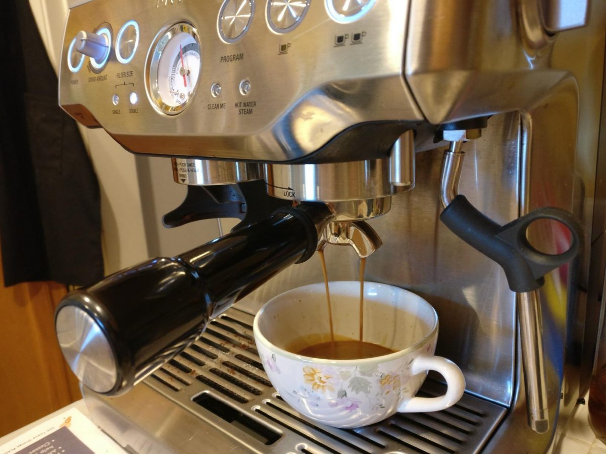 Breville espresso machine making a latte 