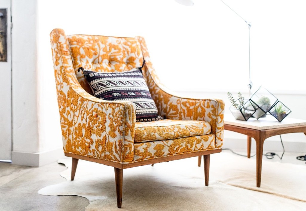 orange and white paisley floral accent chair with sunlight