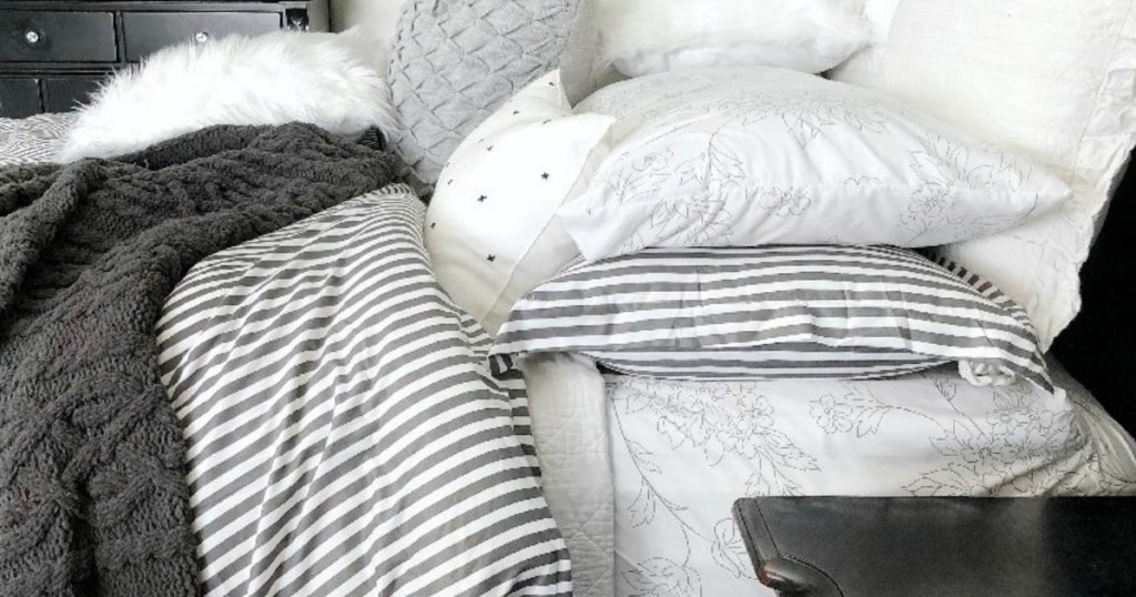 striped duvet set on bed with blankets and pillows