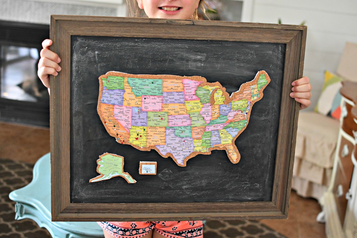 holding framed cork board travel map