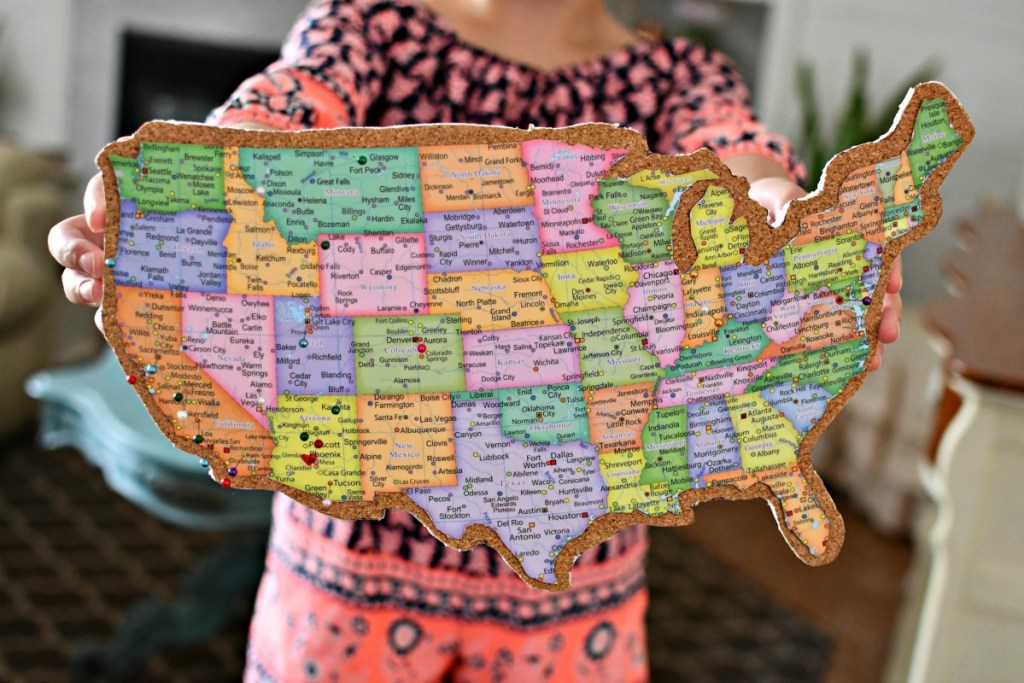 holding a US cork push pin map of travels