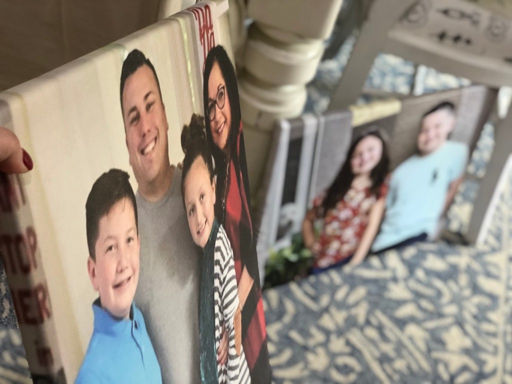 holding personalized photo canvas prints of family 