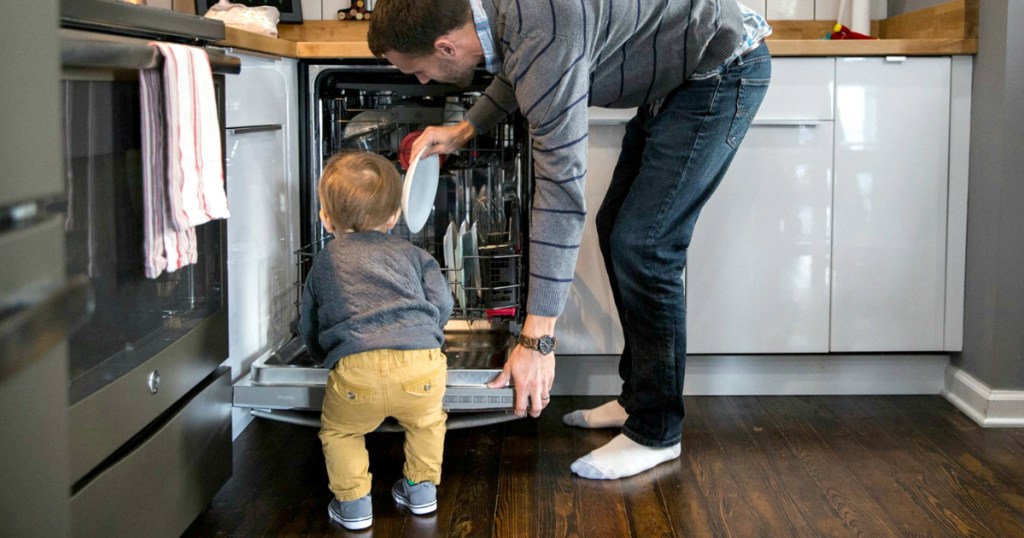 man and toddler loading dishwasher