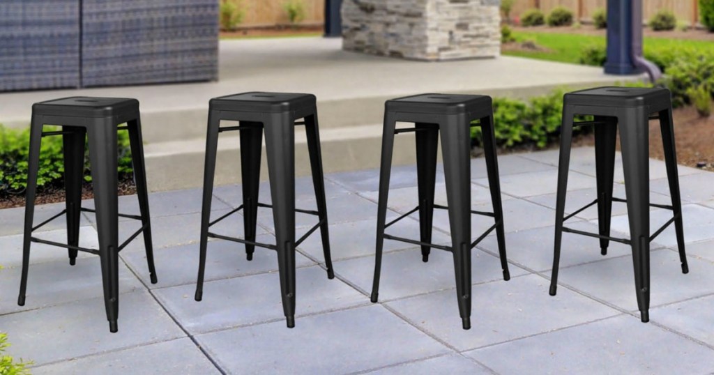 4 metal bar stools in backyard 