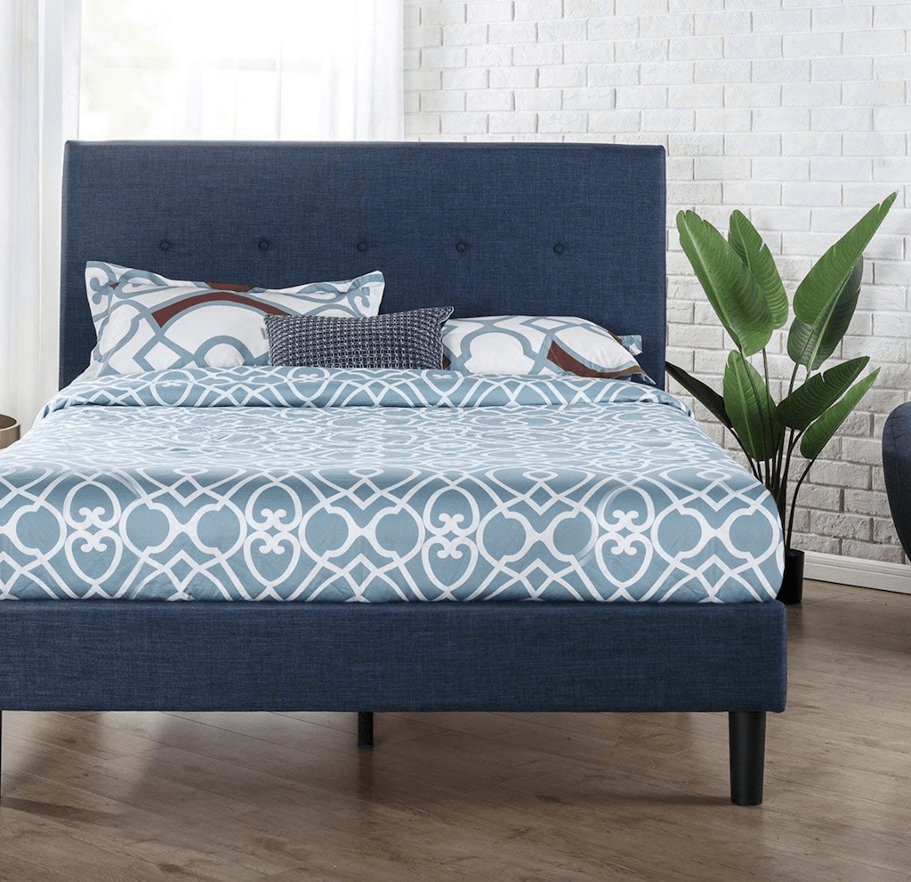 navy platform bed with pillows and bedding 