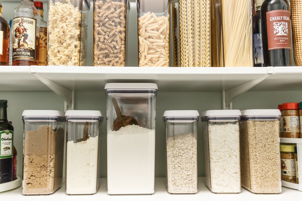 two rows of organized dry foods in oxo plastic containers