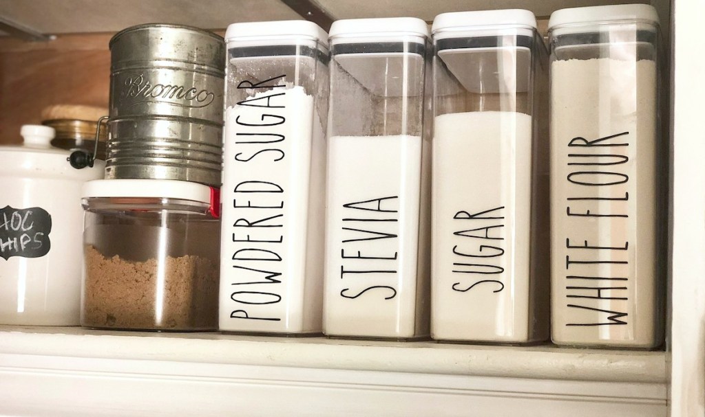 row of white pantry food in clear labeled containers