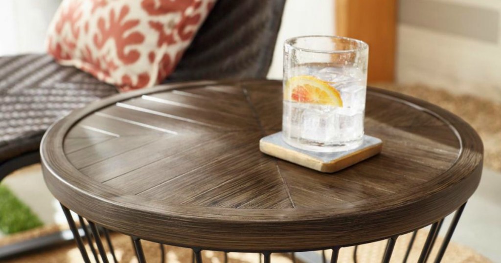 modern patio table by wicker chair 