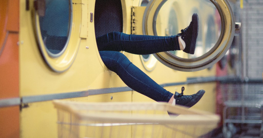 person sitting in washing machine