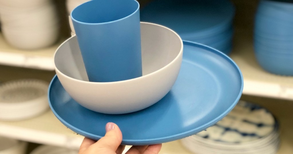 holding plastic dinnerware set at Target 