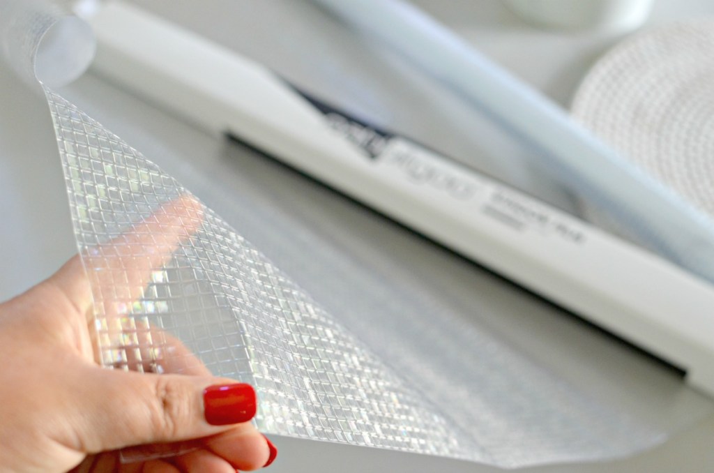 holding a roll of privacy window film