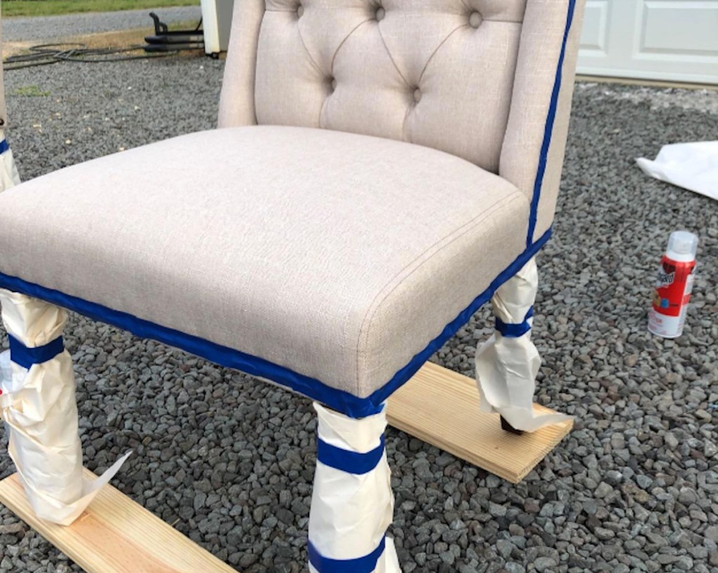 upholstered chair with blue tape on edges outside